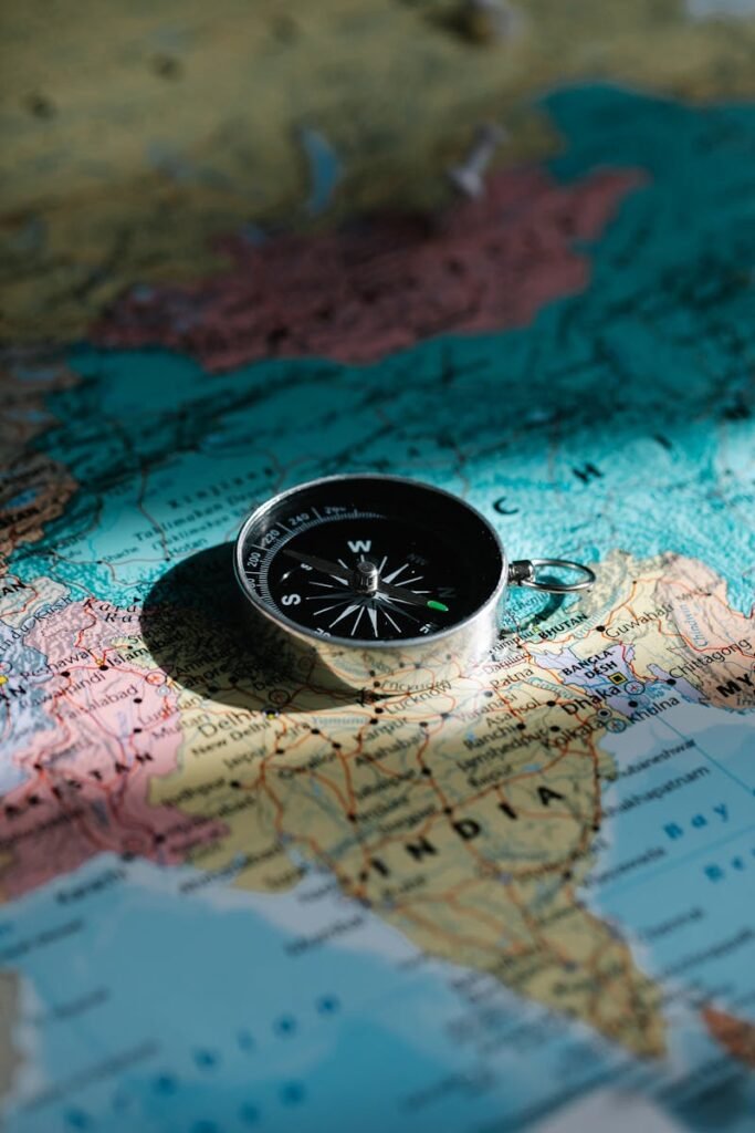 A close-up shot of a compass resting on a map of India, symbolizing exploration and travel.